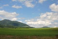 View of beautiful landscape in the Alps with fields Royalty Free Stock Photo