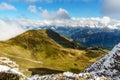 View of beautiful landscape in the Alps with fresh green meadows and snow capped mountain tops