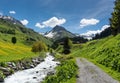 Beautiful mountain valley near Klosters on a summer day with a small creek running through it