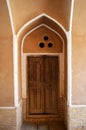 View of a beautiful old Iranian door on the walls of an old house in Yazd, Yazd has a unique Iranian architecture.