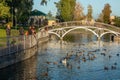 Kremenchuk city, Ukraine - October 7, 2022: View of a beautiful pond with an iron pedestrian bridge in the city garden