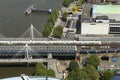 View on beautiful railway bridge across thames river to famous Charing cross railway station. Colored train whizz along the track