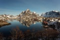 View of beautiful Sacrisoya village in winter time with montains in background with light of sunrise. Lofoten, Norway