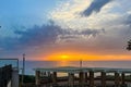 View of a beautiful sunset and a stone canopy gazebo on the seashore in Netanya