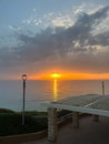 View of a beautiful sunset and a stone canopy gazebo on the seashore in Netanya