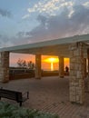 View of a beautiful sunset and a stone canopy gazebo on the seashore in Netanya