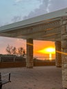 View of a beautiful sunset and a stone canopy gazebo on the seashore in Netanya