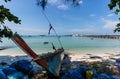 View of beautiful tropical beach and sea in Koh Samui, Thailand with a fishing boat in foreground.