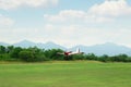 View of beautiful ultralight airplane flying above field Royalty Free Stock Photo