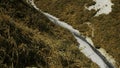 View of beautiful valley with river and grass by white rocks. Clip. Narrow path on steep slope with river at foot of Royalty Free Stock Photo