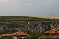 View of the beautiful village of Cherven village, Bulgaria, located below, above and in the high limestone cliffs