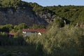 View of the beautiful village of Nisovo, Bulgaria, located below, above and in the high limestone cliffs