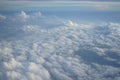 View of beautiful wide wonderland cloudscape with shades of blue sky background from flying plane window Royalty Free Stock Photo