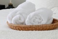 rolled white bath towels, bed decor, basket, resort, hotel