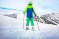 View from behind of the boy ski downhill on slope Royalty Free Stock Photo