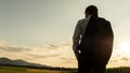 View from behind of a businessman standing with jacket over his Royalty Free Stock Photo