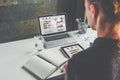 View from behind, businesswoman sitting at desk and working. Student learning online. Business planning.