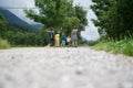 View from behind of a family of five standing at a crossing of hiking paths