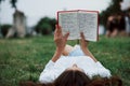 View from behind. Girl lying down on the green grass and have a rest Royalty Free Stock Photo