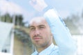 View from behind glass.businessman looking out the window of the office. Royalty Free Stock Photo