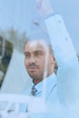 View from behind glass.confident businessman looking out the window of his office Royalty Free Stock Photo