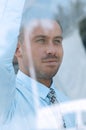 View from behind glass.confident businessman looking out the window of his office Royalty Free Stock Photo