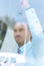 View from behind glass.confident businessman looking out the window of his office Royalty Free Stock Photo