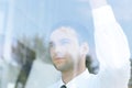 View from behind glass.confident businessman looking out the window of his office Royalty Free Stock Photo