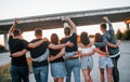 View from behind. Group of young cheerful friends having fun together. Party outdoors Royalty Free Stock Photo