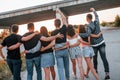 View from behind. Group of young cheerful friends having fun together. Party outdoors Royalty Free Stock Photo