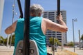 view from behind of a man training on the street with sports machine Royalty Free Stock Photo