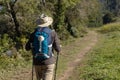 View from behind of a pilgrim walking on his way to Santiago de Compostela on a rural way