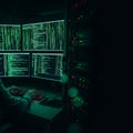 Photorealistic dark photo shows a cybersecurity professional intensely typing on a keyboard, lit solely by glowing green matrix co Royalty Free Stock Photo