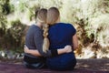 Sisters hugging each other with long hair braided togther