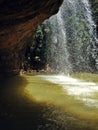 View behind the waterfall at the rock Royalty Free Stock Photo