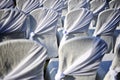 View from behind white wedding seats with gold ribbon decoration Royalty Free Stock Photo