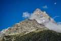 A view of Belalakaya mountain peak. Mountain with slow and blue sky, sunny day.Dombay, Karachay-Cherkess republic