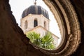 View of the bell tower of the Franciscan Church through a round stone window in Dubrovnik, Croatia Royalty Free Stock Photo