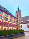 The view on bell tower of Martinskirche with colorful Sevogelbrunnen fountain on the foreground, Basel, Switzerland