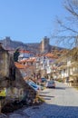 view of the belltower of Church St. Bogorodica Perivlepta through old style street with traditional houes in ohrid