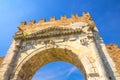 View from below of ancient brick wall and stone gate Arch of Augustus Arco di Augusto ruins in Rimini Royalty Free Stock Photo