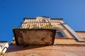 View from below of the balcony of an old building with architectural elements on the facade Royalty Free Stock Photo