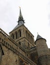 view from below of bell tower with statue of the archangel Michael in the Mont Saint Michel Abbey in France Royalty Free Stock Photo