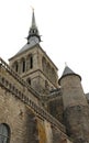 view from below of bell tower with the golden statue of the archangel Michael in Mont Saint Michel Abbey