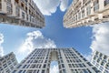 view from below into blue sky with clouds of large modern skyscraper residential complex with arch Royalty Free Stock Photo