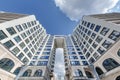 view from below into blue sky with clouds of large modern skyscraper residential complex with arch Royalty Free Stock Photo