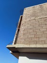 View from below of a building facade under construction. Wall and pillars of a building under construction under a blue sky. Royalty Free Stock Photo