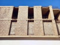 View from below of a building facade under construction. Wall and pillars of a building under construction under a blue sky. Royalty Free Stock Photo