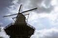 View of below of De Gooyer, iconic octogonal windmill in Amsterdam, Netherlands. Cloudy sky in the background.