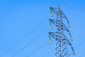 An electricity pylon supporting a high-voltage power line against blue sky Royalty Free Stock Photo